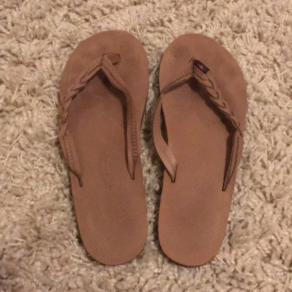 Rainbow braided flip flops.